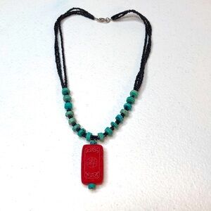 Necklace with turquise beads and red pendant with Chinese longevity symbol